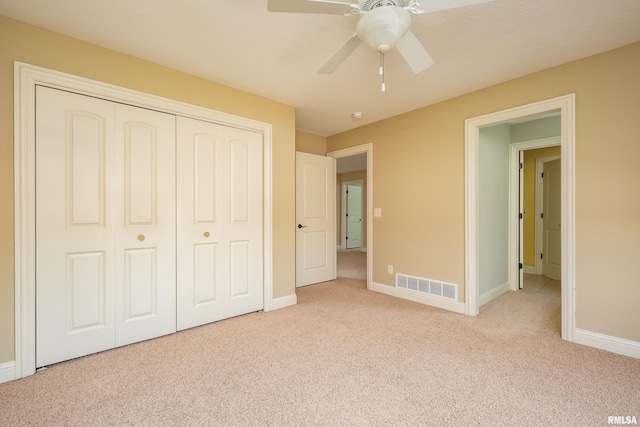 unfurnished bedroom featuring a closet, visible vents, baseboards, and carpet floors