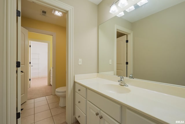 bathroom featuring tile patterned floors, toilet, and vanity