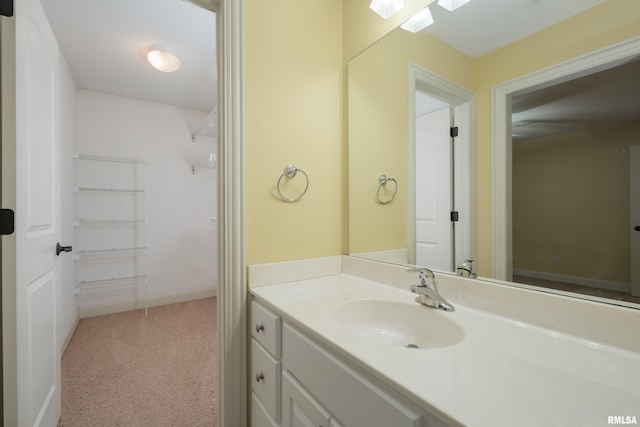 bathroom featuring baseboards and vanity