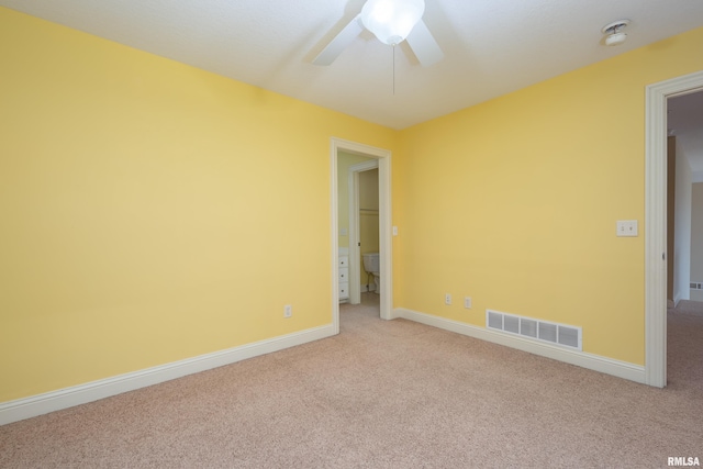 unfurnished room with a ceiling fan, baseboards, visible vents, and light carpet