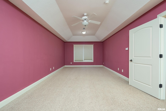 additional living space featuring baseboards, light carpet, and a ceiling fan