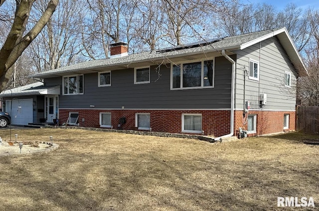 exterior space featuring a garage and a chimney