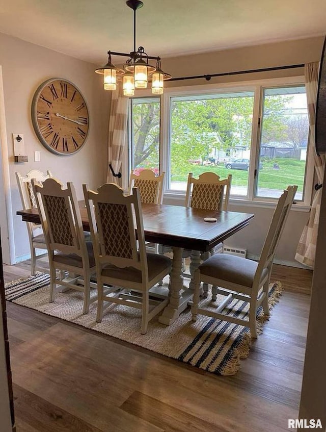 dining area featuring an inviting chandelier and wood finished floors