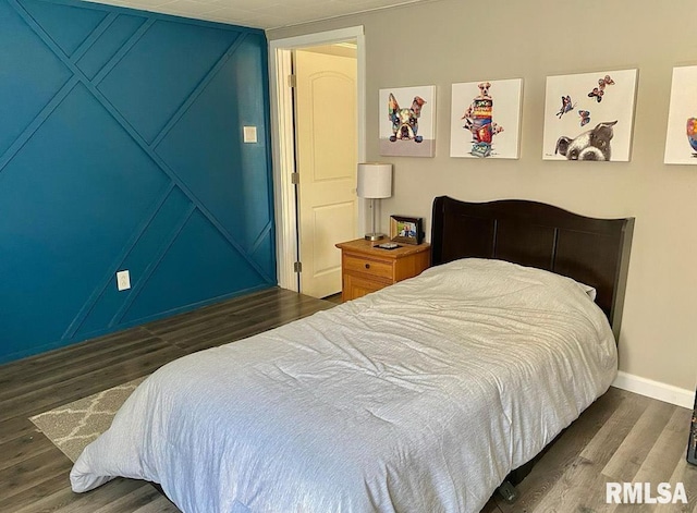 bedroom featuring wood finished floors and baseboards