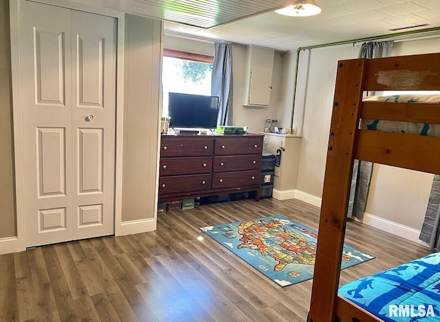 bedroom featuring dark wood-style floors and baseboards