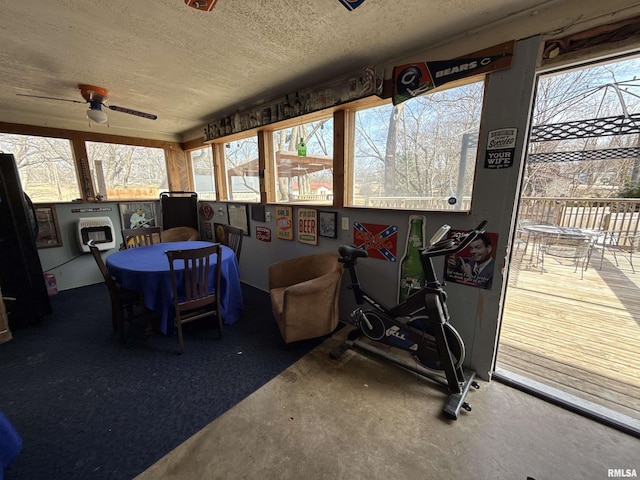 sunroom with a wealth of natural light and a ceiling fan