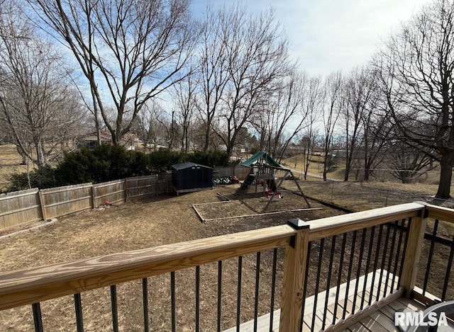 wooden terrace with fence and a playground