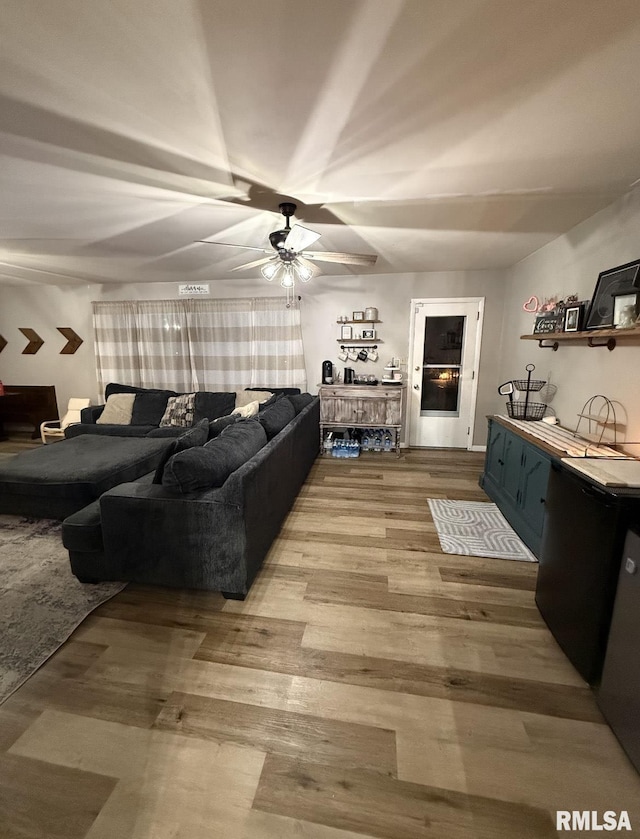 living area featuring wood finished floors and ceiling fan