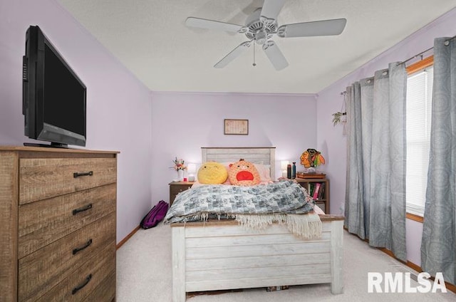 carpeted bedroom featuring multiple windows and a ceiling fan