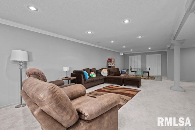 living room featuring a textured ceiling, carpet, crown molding, and ornate columns