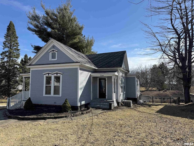 view of home's exterior with central air condition unit, roof with shingles, and fence