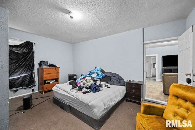 carpeted bedroom with a textured ceiling