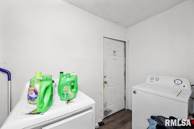 washroom with a textured ceiling, dark wood-type flooring, laundry area, and washing machine and clothes dryer