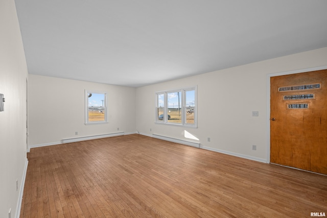 unfurnished living room featuring light wood-style floors, baseboards, and baseboard heating