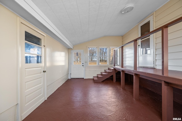 mudroom with concrete flooring and vaulted ceiling