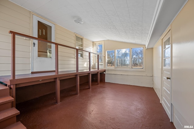 unfurnished sunroom with lofted ceiling