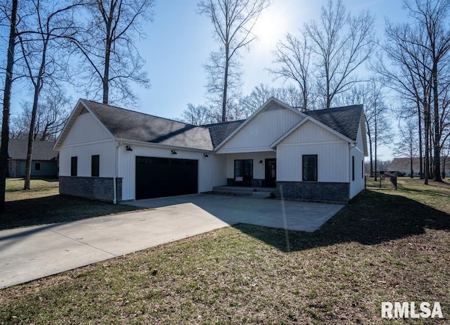 modern inspired farmhouse featuring stone siding, a front yard, concrete driveway, and an attached garage