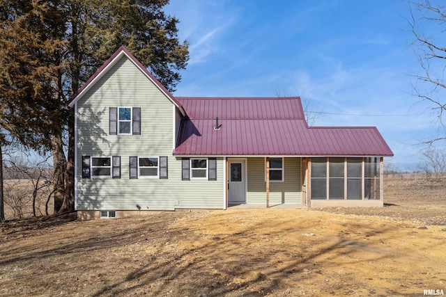 traditional-style house with metal roof and a sunroom