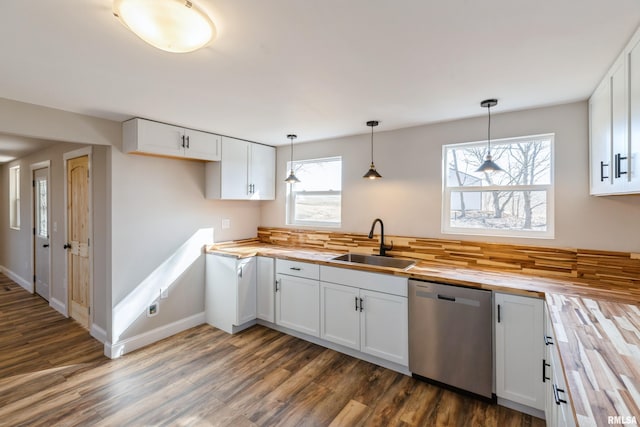 kitchen with a sink, dark wood-style floors, white cabinetry, wooden counters, and dishwasher