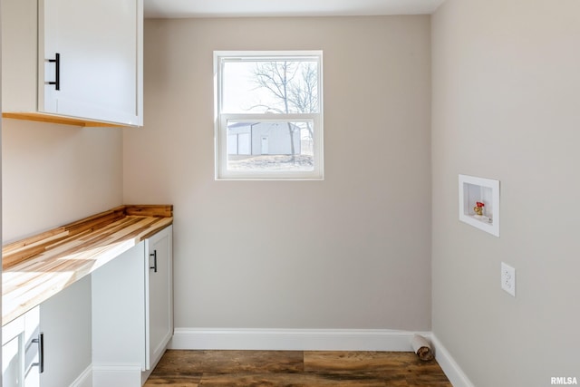 laundry room with hookup for a washing machine, cabinet space, dark wood-style flooring, and baseboards