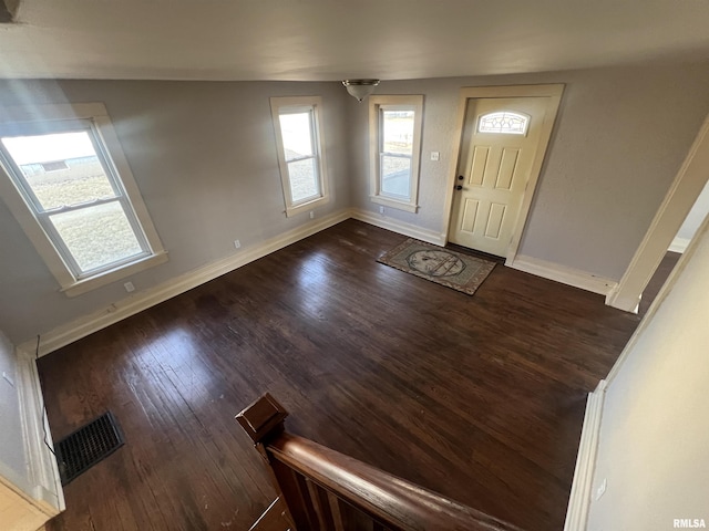 entrance foyer featuring visible vents, baseboards, and dark wood-style flooring