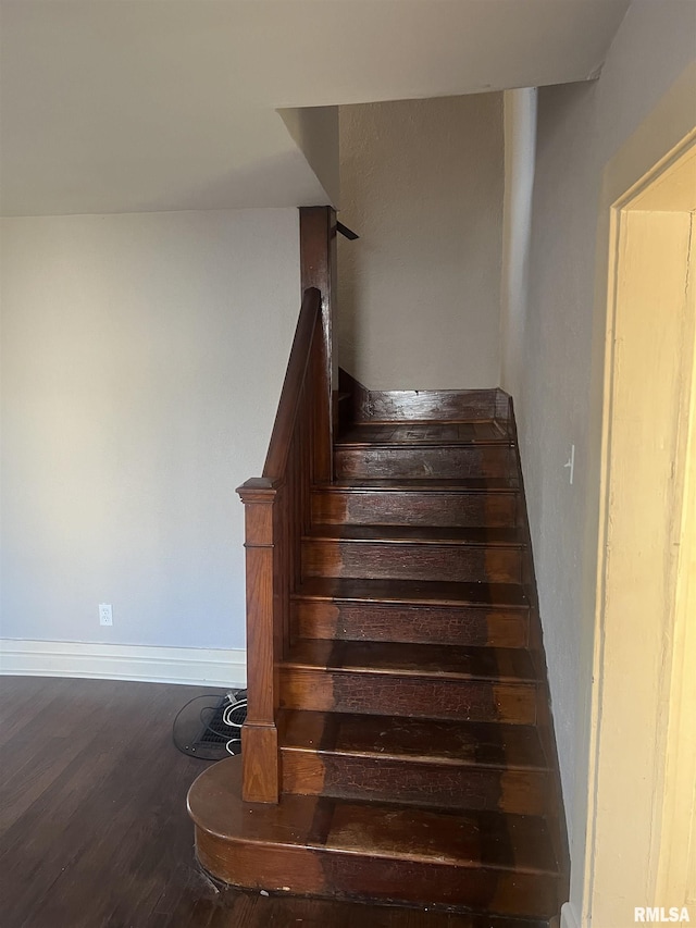 stairway with baseboards and wood finished floors