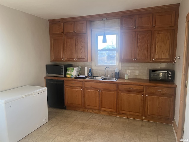 kitchen with brown cabinets, a sink, backsplash, fridge, and dishwasher