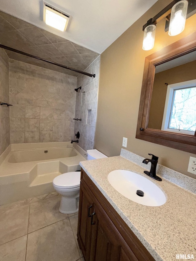 bathroom featuring tile patterned floors, tub / shower combination, toilet, and vanity