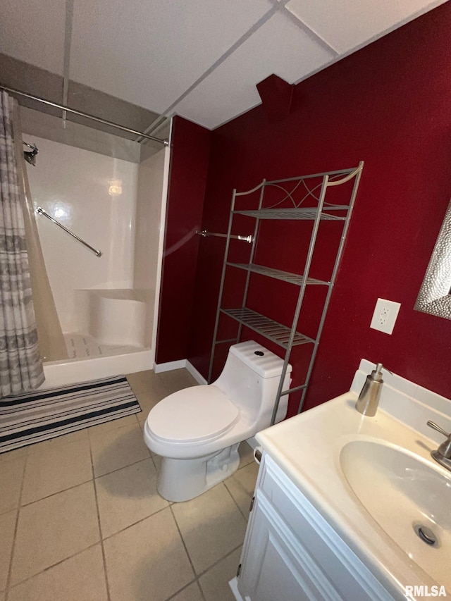 bathroom featuring tile patterned floors, toilet, a shower with shower curtain, and vanity