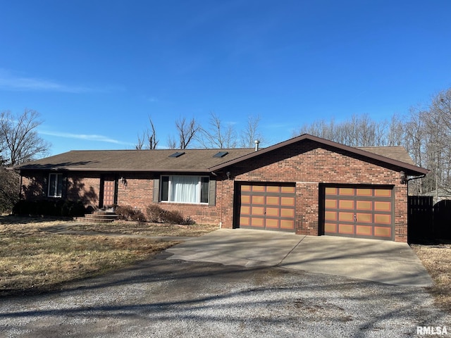 ranch-style house featuring concrete driveway, a garage, brick siding, and roof with shingles