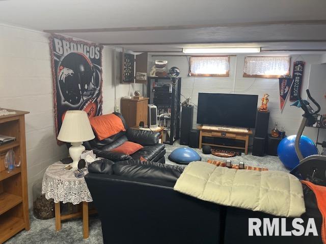 living area featuring concrete block wall