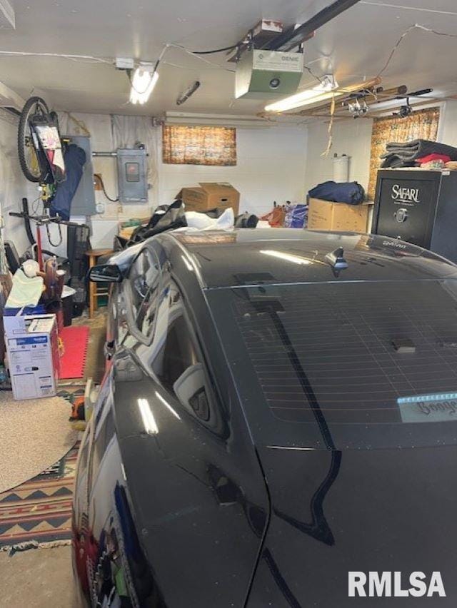 garage with electric panel and a garage door opener