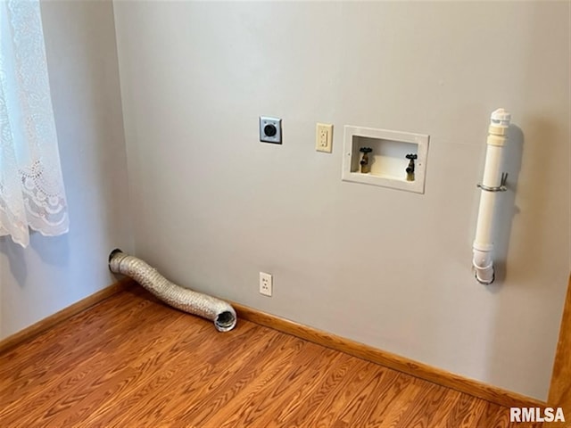 clothes washing area with electric dryer hookup, baseboards, washer hookup, and wood finished floors