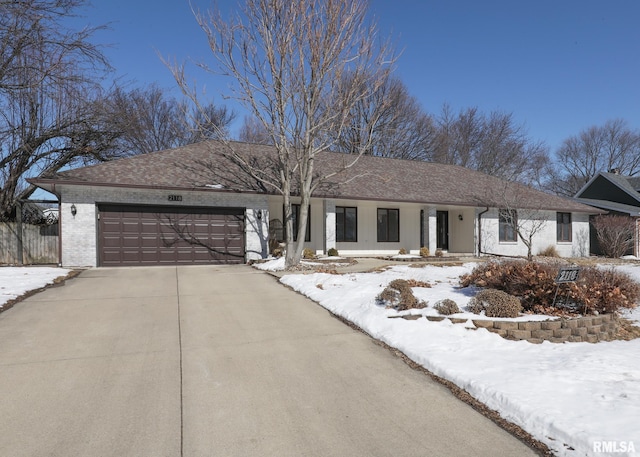 ranch-style home with brick siding, driveway, and a garage