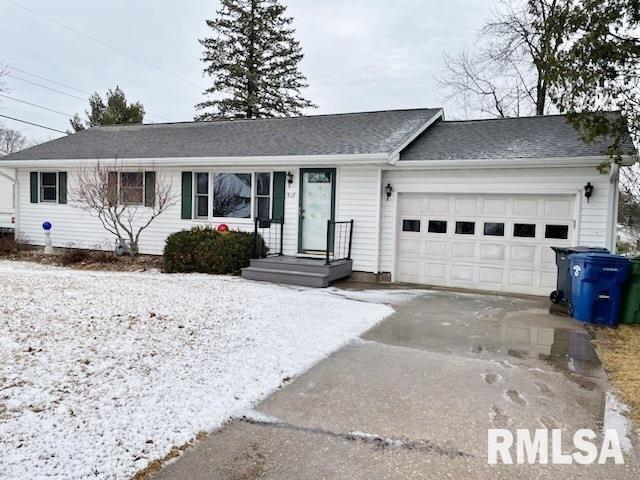 single story home with driveway and an attached garage