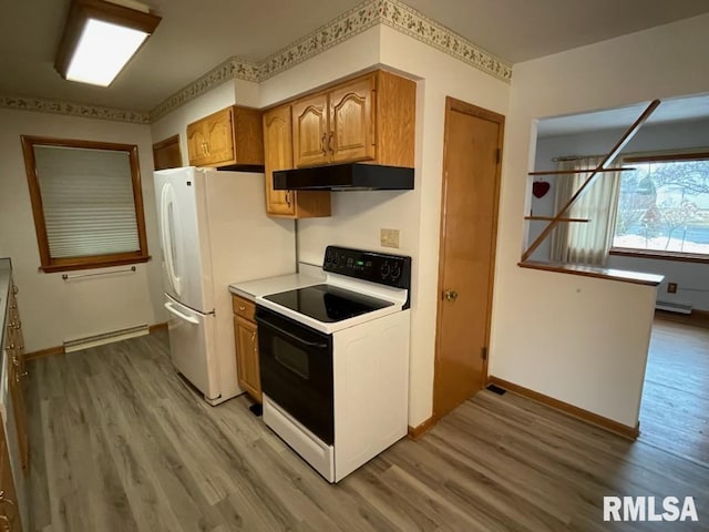 kitchen with baseboards, light wood finished floors, freestanding refrigerator, under cabinet range hood, and range with electric stovetop