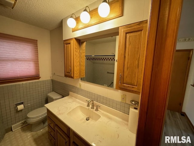 full bath with tile walls, walk in shower, toilet, wainscoting, and a textured ceiling