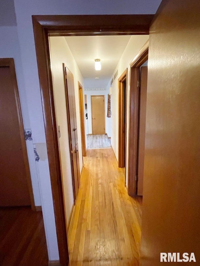 hallway with light wood-type flooring and visible vents