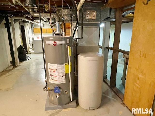 utility room featuring water heater and washer / clothes dryer