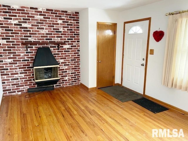 entrance foyer featuring baseboards and wood finished floors