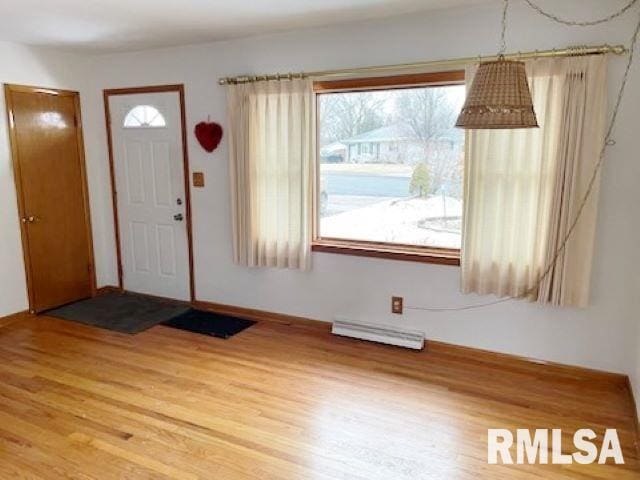 entryway featuring light wood finished floors and a baseboard radiator