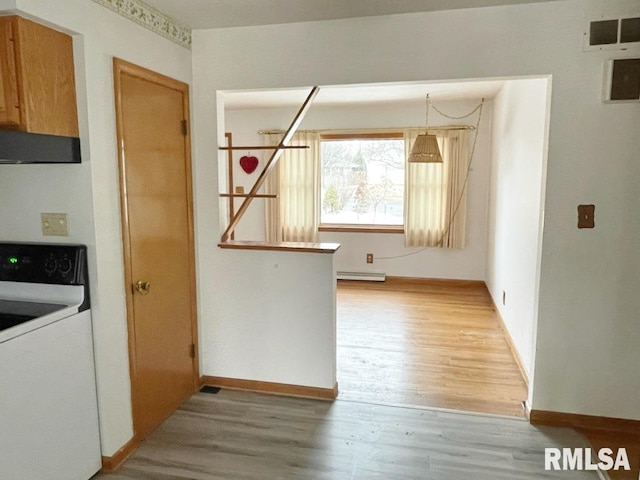 kitchen featuring visible vents, baseboard heating, light wood-style flooring, electric stove, and extractor fan