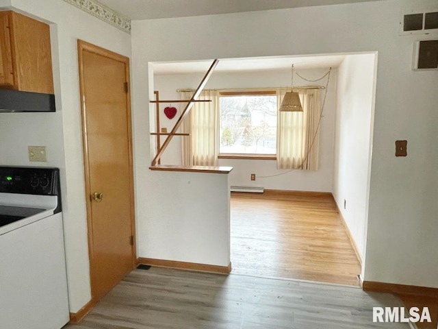 kitchen featuring ventilation hood, visible vents, light wood finished floors, a baseboard radiator, and range with electric cooktop