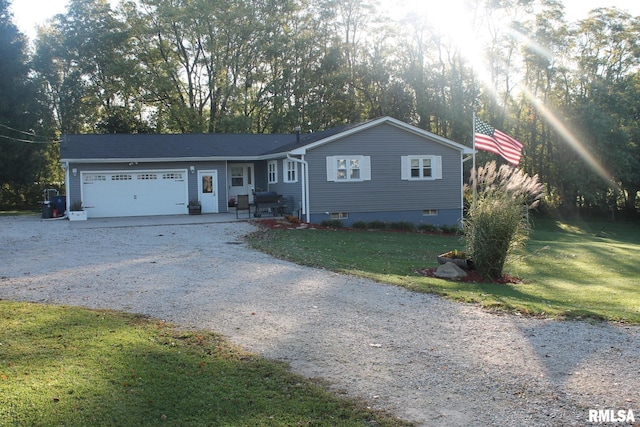 ranch-style home featuring a garage, gravel driveway, and a front lawn