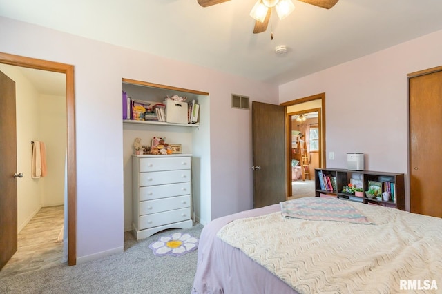 bedroom with visible vents, baseboards, carpet floors, a closet, and a ceiling fan