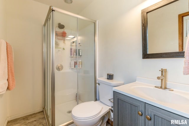 full bathroom with vanity, a shower stall, and toilet