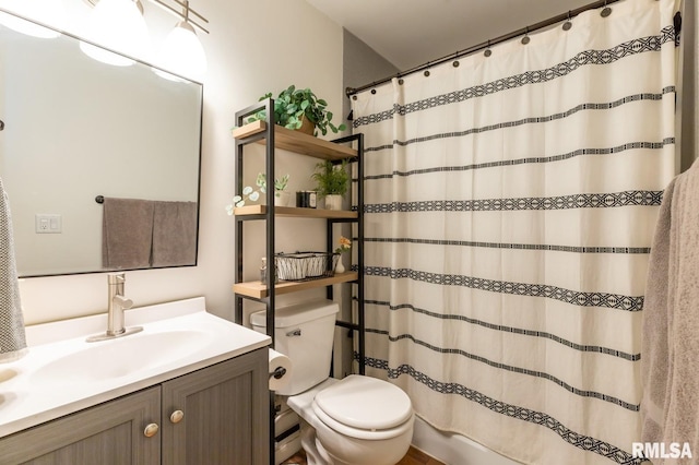 full bathroom with vanity, curtained shower, and toilet