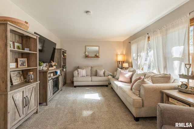 living area featuring plenty of natural light and light colored carpet