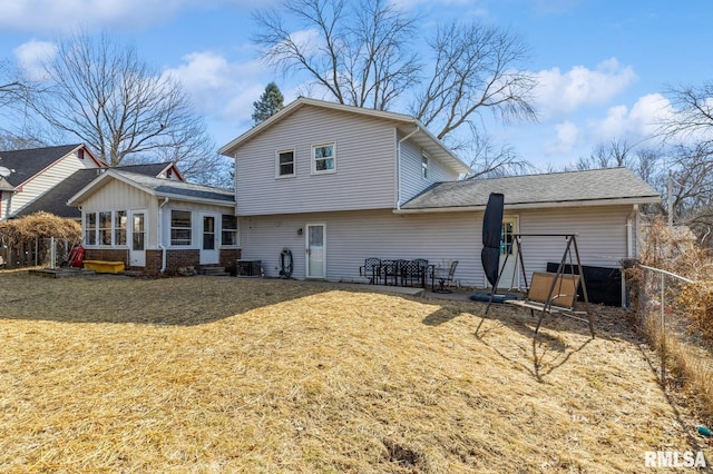 back of house with cooling unit, a sunroom, a lawn, and fence