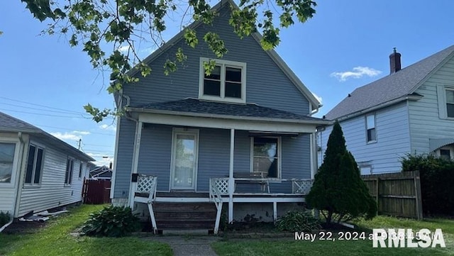 view of front of house featuring covered porch and fence